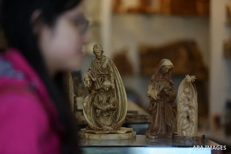 A woden effigies of the the Holy Family are seen at a workshop in the West Bank town of Bethlehem, on December 26, 2016. The traditional birthplace of Jesus Christ prepares to celebrate Christmas. Photo by Shadi Hatem