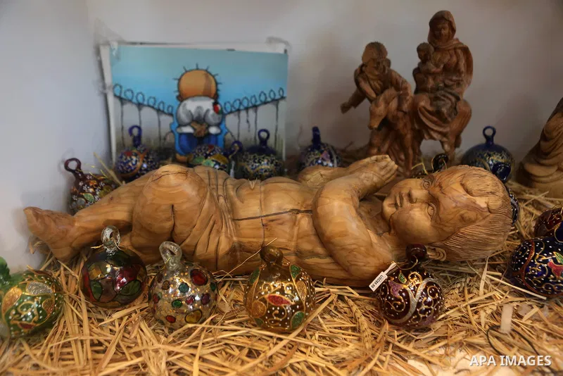 A woden effigies of the the Holy Family are seen at a workshop in the West Bank town of Bethlehem, on December 26, 2016. The traditional birthplace of Jesus Christ prepares to celebrate Christmas. Photo by Shadi Hatem
