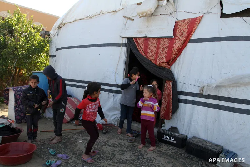 Palestinian children from Abu Jamea family play outside their house which was destroyed during the 50-day war between Israel and Hamas militants in the summer of 2014, on in Khan Younis in the southern Gaza Strip Decembe...