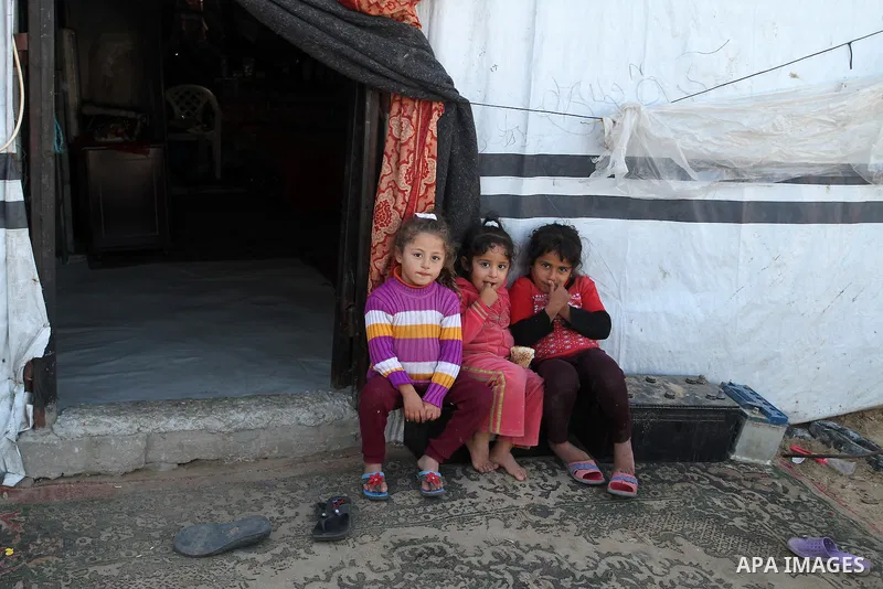 Palestinian children from Abu Jamea family play outside their house which was destroyed during the 50-day war between Israel and Hamas militants in the summer of 2014, on in Khan Younis in the southern Gaza Strip Decembe...
