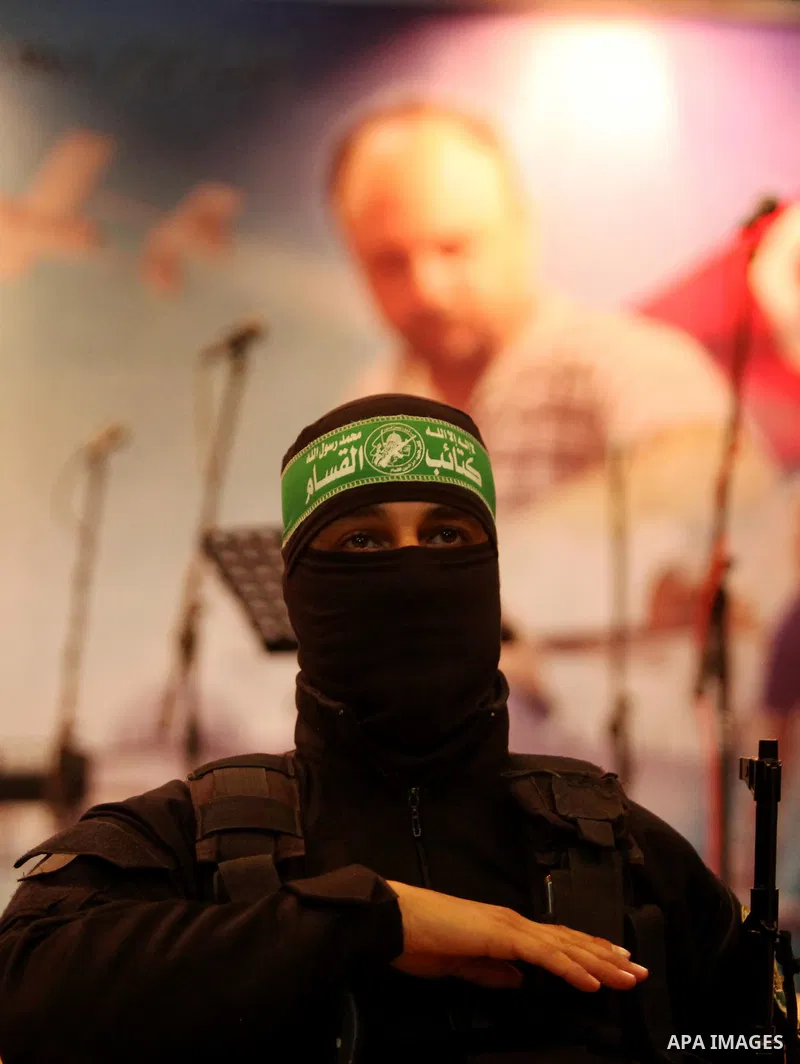 Palestinian members of Ezzedeen al-Qassam, the armed wing of Hamas movement, participate in a memorial service for a Tunisian Mohamed Zaouari, who was murdered in Tunisia in Gaza city on December 26, 2016. Zaouari, 49, w...