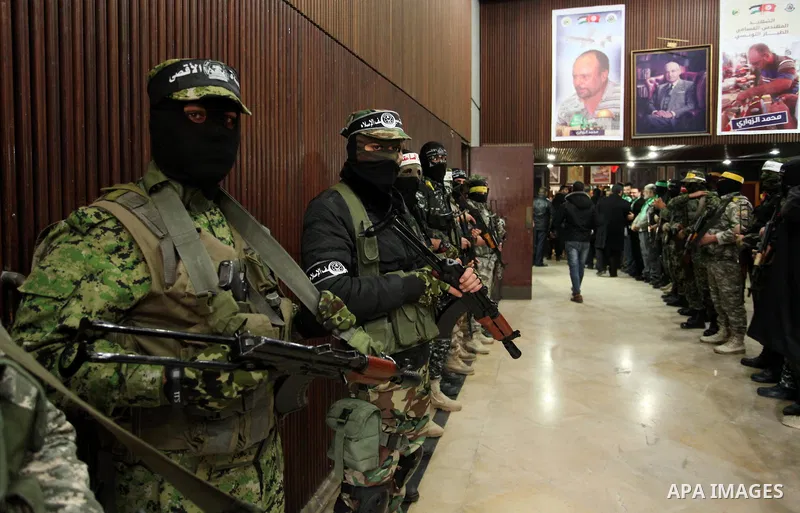 Palestinian members of Ezzedeen al-Qassam, the armed wing of Hamas movement, participate in a memorial service for a Tunisian Mohamed Zaouari, who was murdered in Tunisia in Gaza city on December 26, 2016. Zaouari, 49, w...