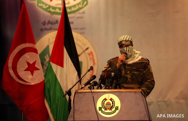 Palestinian members of Ezzedeen al-Qassam, the armed wing of Hamas movement, participate in a memorial service for a Tunisian Mohamed Zaouari, who was murdered in Tunisia in Gaza city on December 26, 2016. Zaouari, 49, w...