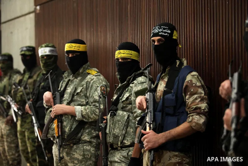 Palestinian members of Ezzedeen al-Qassam, the armed wing of Hamas movement, participate in a memorial service for a Tunisian Mohamed Zaouari, who was murdered in Tunisia in Gaza city on December 26, 2016. Zaouari, 49, w...