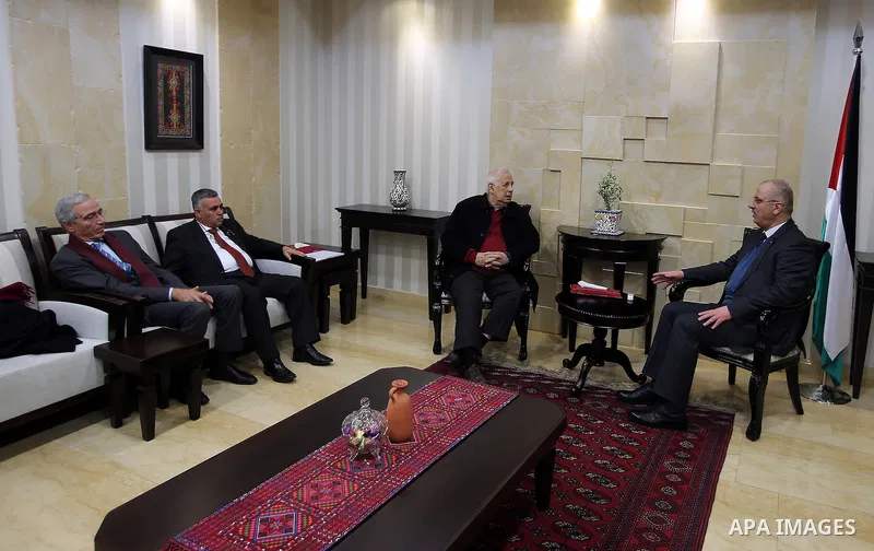 Palestinian Prime Minister, Rami Hamdallah, meets with the Palestinian chief of Election Commissioner, Hanna Nasser, in the West Bank city of Ramallah, on December 28, 2016. Photo by Prime Minister Office