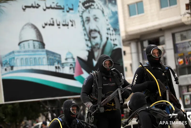 Palestinian naval security forces march during a rally marking the Eighth anniversary of the Israeli attack on Gaza strip in 2009, in Gaza city on December 28, 2016. Photo by Ashraf Amra