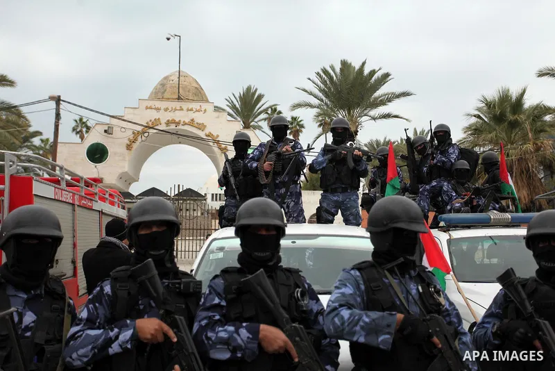 Palestinian police officers march during a rally marking the Eighth anniversary of the Israeli attack on Gaza strip in 2009, in Gaza city on December 28, 2016. Photo by Ashraf Amra