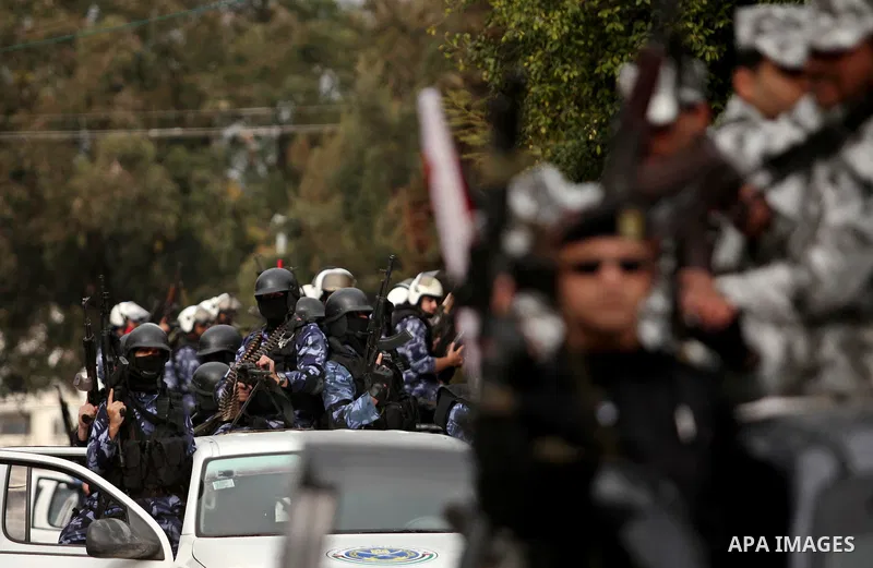 Palestinian police officers march during a rally marking the Eighth anniversary of the Israeli attack on Gaza strip in 2009, in Gaza city on December 28, 2016. Photo by Ashraf Amra