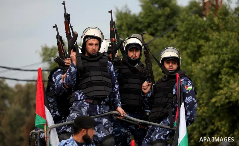 Palestinian police officers march during a rally marking the Eighth anniversary of the Israeli attack on Gaza strip in 2009, in Gaza city on December 28, 2016. Photo by Ashraf Amra