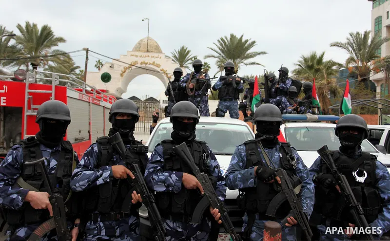 Palestinian police officers march during a rally marking the Eighth anniversary of the Israeli attack on Gaza strip in 2009, in Gaza city on December 28, 2016. Photo by Ashraf Amra