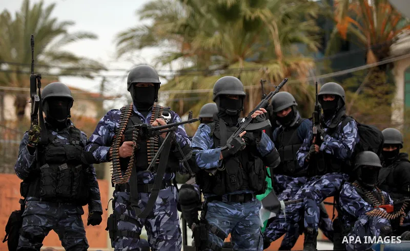 Palestinian police officers march during a rally marking the Eighth anniversary of the Israeli attack on Gaza strip in 2009, in Gaza city on December 28, 2016. Photo by Ashraf Amra