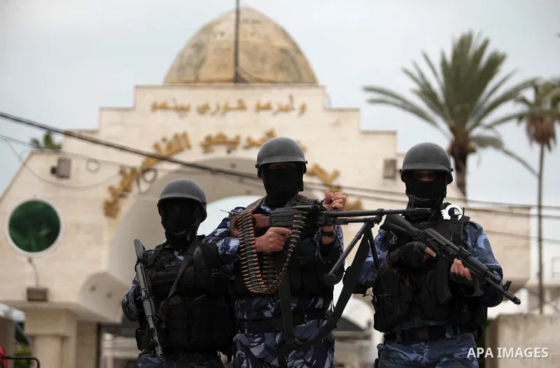 Palestinian police officers march during a rally marking the Eighth anniversary of the Israeli attack on Gaza strip in 2009, in Gaza city on December 28, 2016. Photo by Ashraf Amra