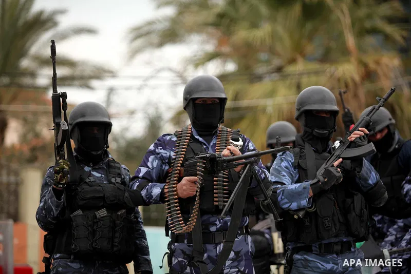 Palestinian police officers march during a rally marking the Eighth anniversary of the Israeli attack on Gaza strip in 2009, in Gaza city on December 28, 2016. Photo by Ashraf Amra