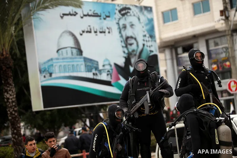 Palestinian naval security forces march during a rally marking the Eighth anniversary of the Israeli attack on Gaza strip in 2009, in Gaza city on December 28, 2016. Photo by Ashraf Amra