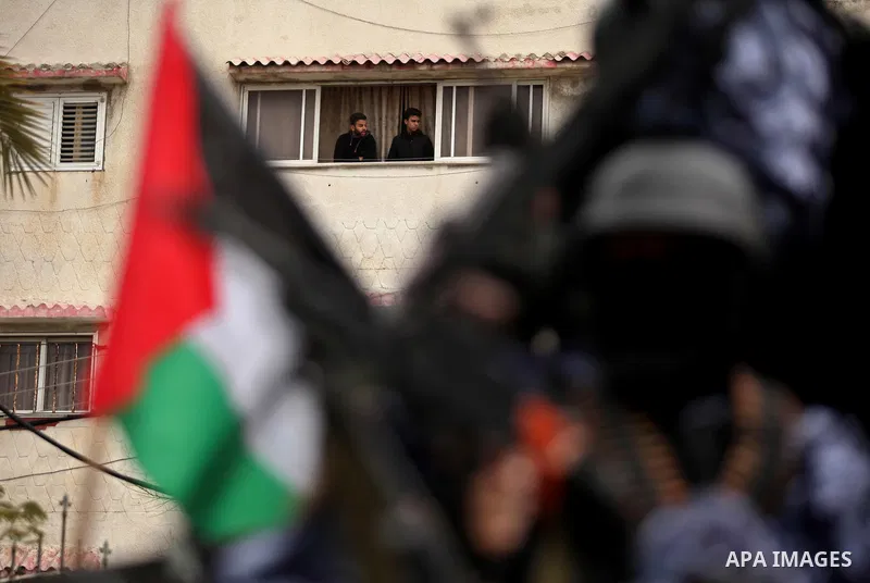 Palestinian police officers march during a rally marking the Eighth anniversary of the Israeli attack on Gaza strip in 2009, in Gaza city on December 28, 2016. Photo by Ashraf Amra