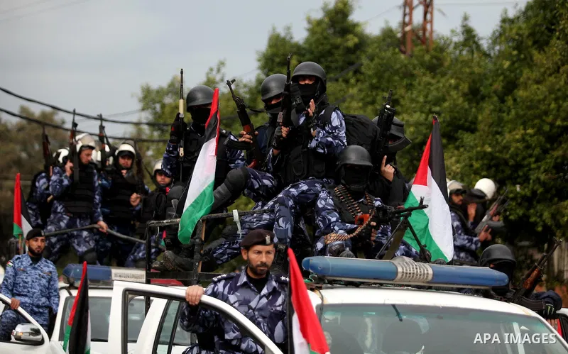 Palestinian police officers march during a rally marking the Eighth anniversary of the Israeli attack on Gaza strip in 2009, in Gaza city on December 28, 2016. Photo by Ashraf Amra