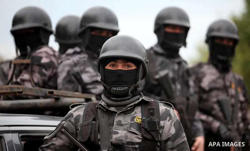 Palestinian police officers march during a rally marking the Eighth anniversary of the Israeli attack on Gaza strip in 2009, in Gaza city on December 28, 2016. Photo by Ashraf Amra