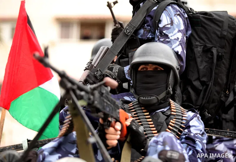 Palestinian police officers march during a rally marking the Eighth anniversary of the Israeli attack on Gaza strip in 2009, in Gaza city on December 28, 2016. Photo by Ashraf Amra