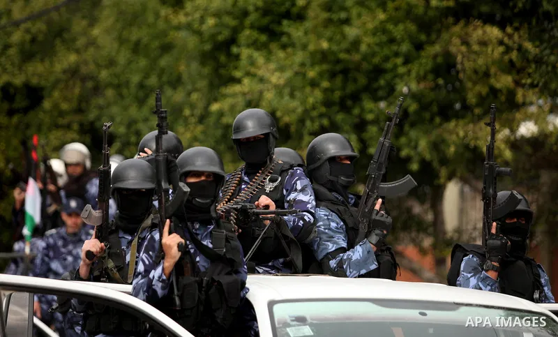 Palestinian police officers march during a rally marking the Eighth anniversary of the Israeli attack on Gaza strip in 2009, in Gaza city on December 28, 2016. Photo by Ashraf Amra