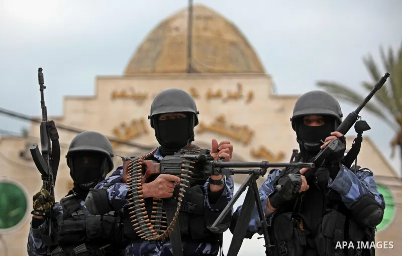 Palestinian police officers march during a rally marking the Eighth anniversary of the Israeli attack on Gaza strip in 2009, in Gaza city on December 28, 2016. Photo by Ashraf Amra