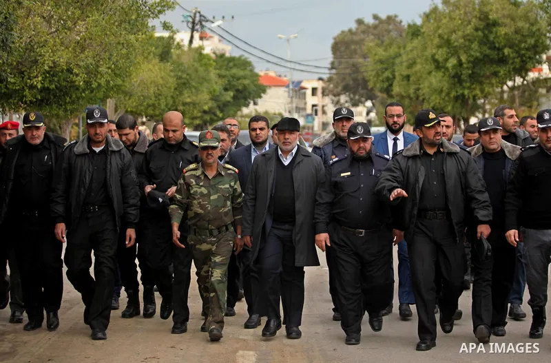 Palestinian police officers march during a rally marking the Eighth anniversary of the Israeli attack on Gaza strip in 2009, in Gaza city on December 28, 2016. Photo by Ashraf Amra