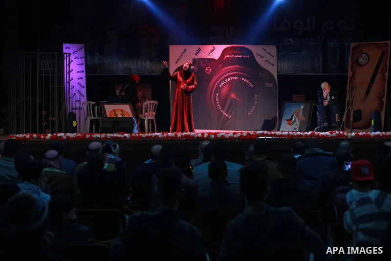 Palestinians attend the operetta entitled "camera and pen" during the events on the al-Wafa' of the Palestinian journalist, in Gaza city on December 29, 2016. Photo by Mohammed Asad