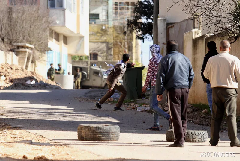 Palestinian protesters hurl stones during clashes with Israeli security forces following a demonstration against the expropriation of Palestinian land by Israel in the village of Kfar Qaddum, near Nablus, in the occupied...