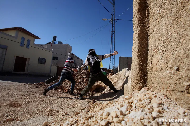 Palestinian protesters hurl stones during clashes with Israeli security forces following a demonstration against the expropriation of Palestinian land by Israel in the village of Kfar Qaddum, near Nablus, in the occupied...