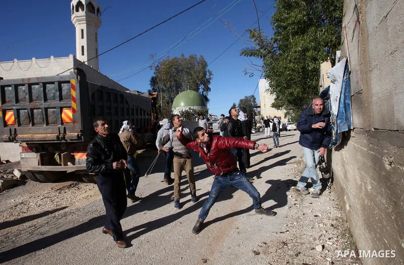 Palestinian protesters hurl stones during clashes with Israeli security forces following a demonstration against the expropriation of Palestinian land by Israel in the village of Kfar Qaddum, near Nablus, in the occupied...