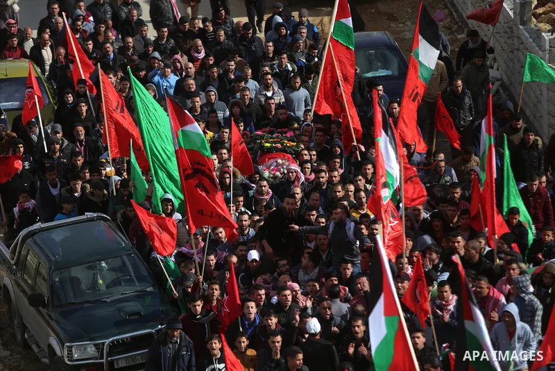Mourners carry the body of Palestinian Maen Nasser al-Din Abu Qaraa, 23, during his funeral after Israel released his body, in the West Bank city of Ramallah, on December 31, 2016. Abu Qaraa was killed by Israeli forces...