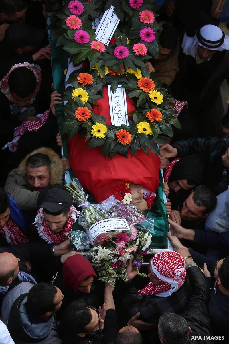 Mourners carry the body of Palestinian Maen Nasser al-Din Abu Qaraa, 23, during his funeral after Israel released his body, in the West Bank city of Ramallah, on December 31, 2016. Abu Qaraa was killed by Israeli forces...
