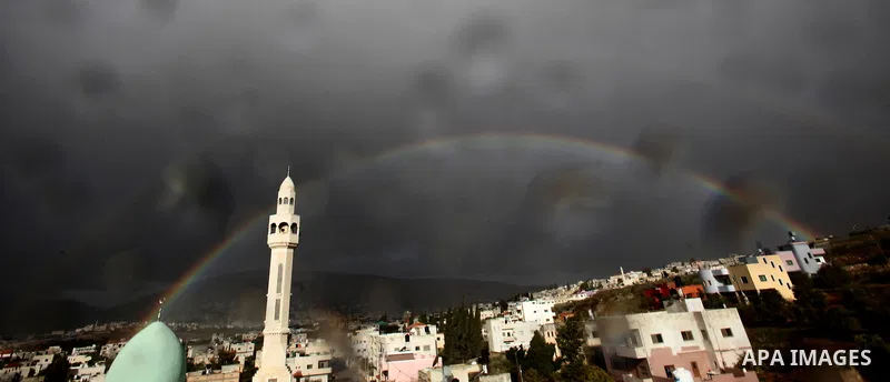 A rainbow is seen over the West Bank city of Nablus on December 31, 2016. Photo by Nedal Eshtayah