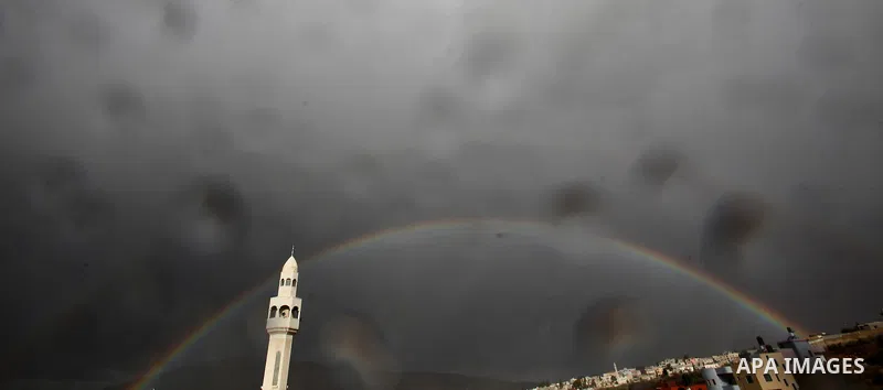 A rainbow is seen over the West Bank city of Nablus on December 31, 2016. Photo by Nedal Eshtayah
