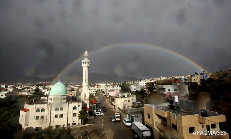A rainbow is seen over the West Bank city of Nablus on December 31, 2016. Photo by Nedal Eshtayah