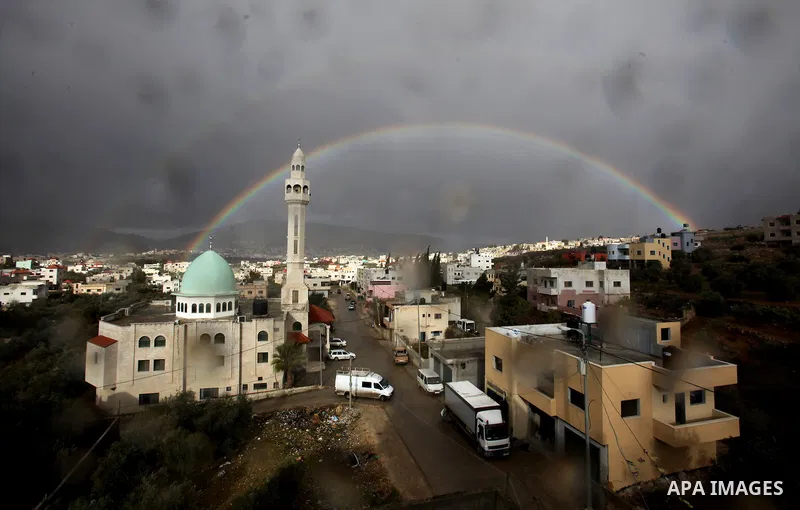 A rainbow is seen over the West Bank city of Nablus on December 31, 2016. Photo by Nedal Eshtayah