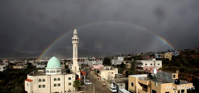 A rainbow is seen over the West Bank city of Nablus on December 31, 2016. Photo by Nedal Eshtayah