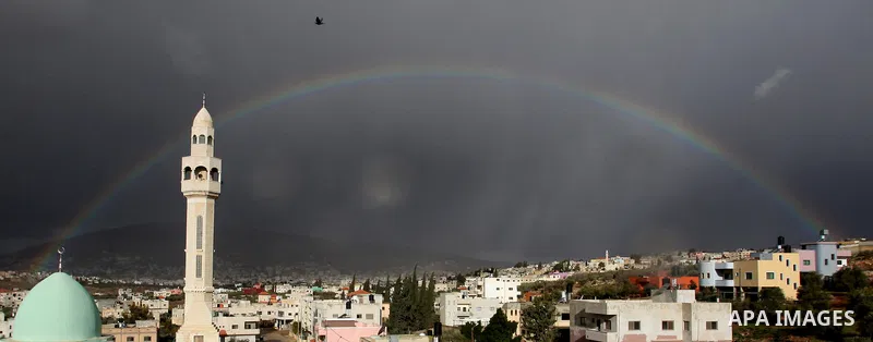 A rainbow is seen over the West Bank city of Nablus on December 31, 2016. Photo by Nedal Eshtayah