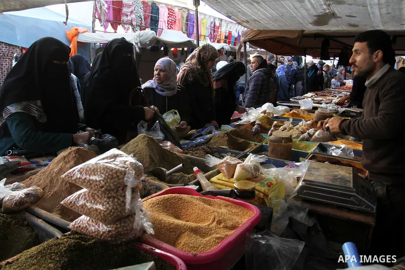 Palestinians shop at a market in Rafah in the southern of Gaza strip, on December 31, 2016. Photo by Abed Rahim Khatib