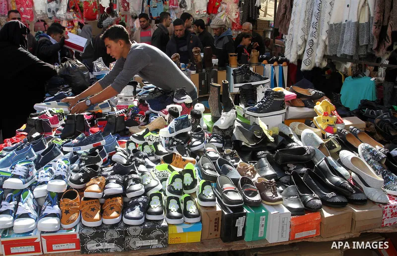 Palestinians shop at a market in Rafah in the southern of Gaza strip, on December 31, 2016. Photo by Abed Rahim Khatib