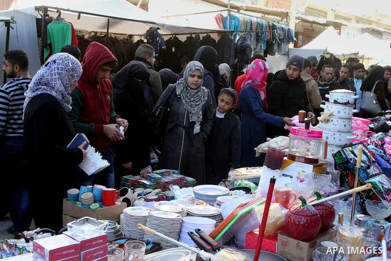 Palestinians shop at a market in Rafah in the southern of Gaza strip, on December 31, 2016. Photo by Abed Rahim Khatib