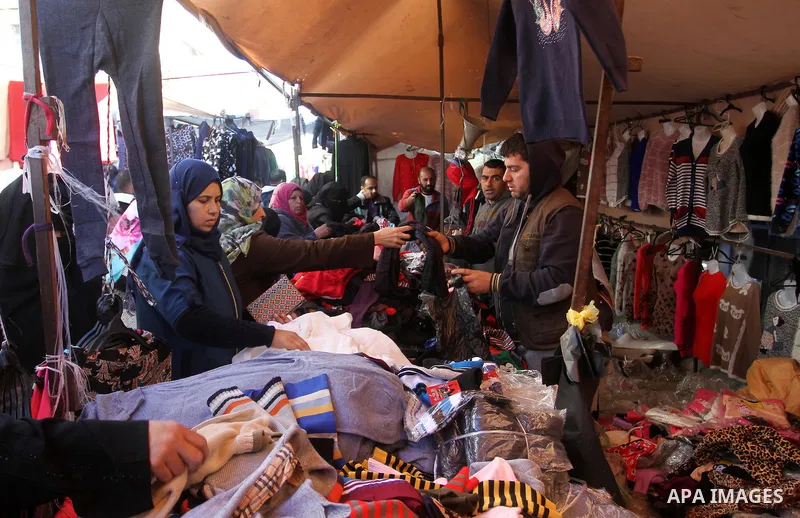 Palestinians shop at a market in Rafah in the southern of Gaza strip, on December 31, 2016. Photo by Abed Rahim Khatib