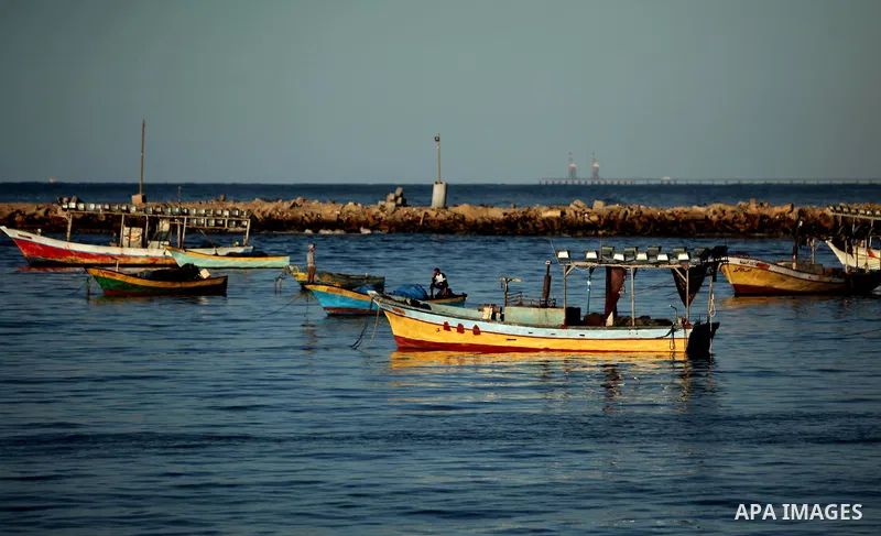 Palestinians ride a boat as they enjoy the last sunset of 2016 on the beach of Gaza City, on December 31, 2016. Photo by Ashraf Amra