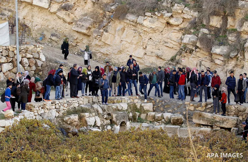 Palestinians take part in the walking tour titled "eyes Tavouh" in the village of Tavouh in the northwest the West bank city of Hebron on the December 31, 2016. Photo by Wisam Hashlamoun