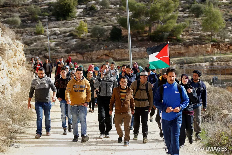 Palestinians take part in the walking tour titled "eyes Tavouh" in the village of Tavouh in the northwest the West bank city of Hebron on the December 31, 2016. Photo by Wisam Hashlamoun