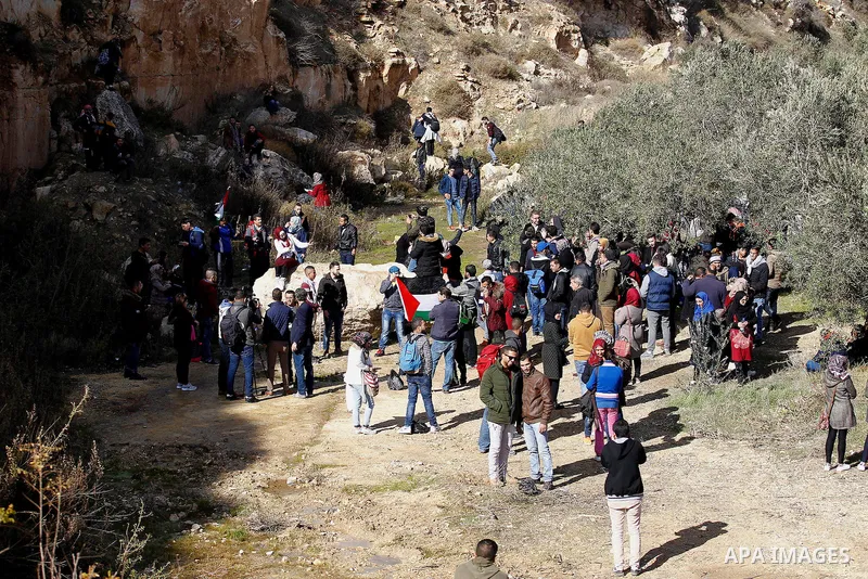 Palestinians take part in the walking tour titled "eyes Tavouh" in the village of Tavouh in the northwest the West bank city of Hebron on the December 31, 2016. Photo by Wisam Hashlamoun