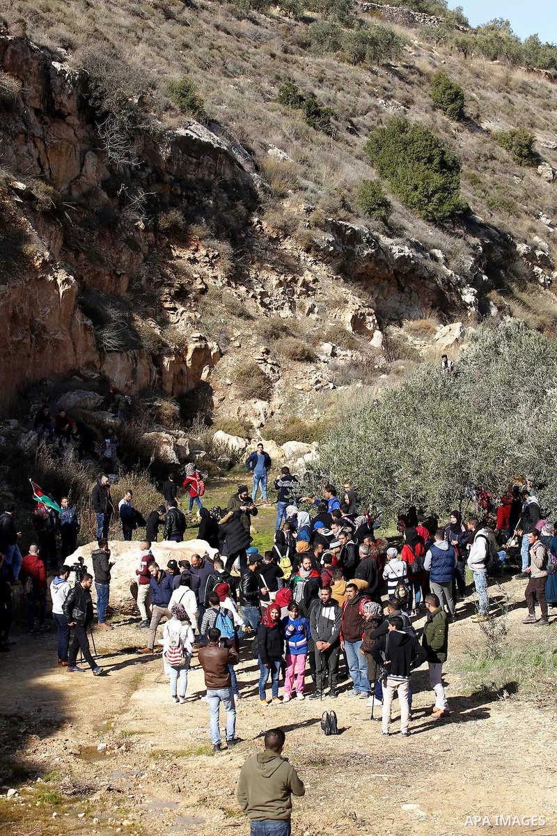 Palestinians take part in the walking tour titled "eyes Tavouh" in the village of Tavouh in the northwest the West bank city of Hebron on the December 31, 2016. Photo by Wisam Hashlamoun