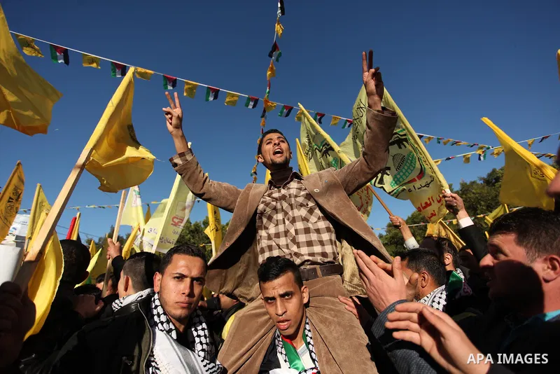 Supporters of the Fatah movement take part in a rally in Gaza City on December 31, 2016, marking the 52nd anniversary of its creation.. Photo by Ashraf Amra