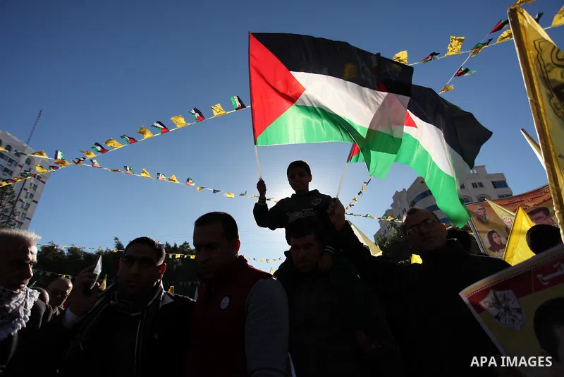 Supporters of the Fatah movement take part in a rally in Gaza City on December 31, 2016, marking the 52nd anniversary of its creation.. Photo by Ashraf Amra