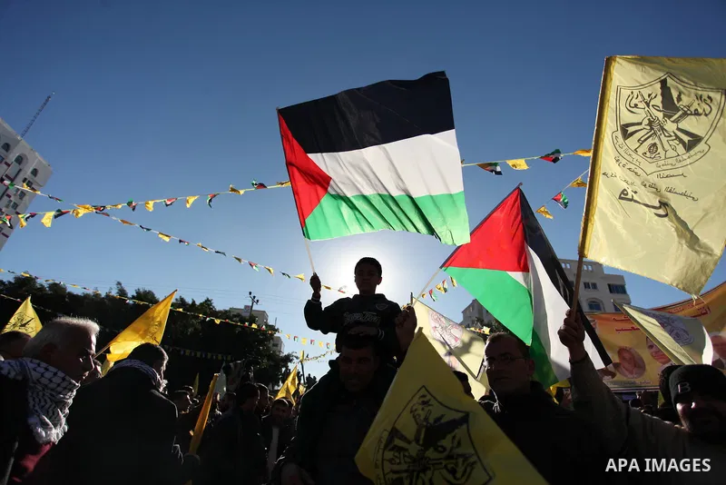 Supporters of the Fatah movement take part in a rally in Gaza City on December 31, 2016, marking the 52nd anniversary of its creation.. Photo by Ashraf Amra