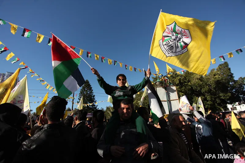 Supporters of the Fatah movement take part in a rally in Gaza City on December 31, 2016, marking the 52nd anniversary of its creation.. Photo by Ashraf Amra